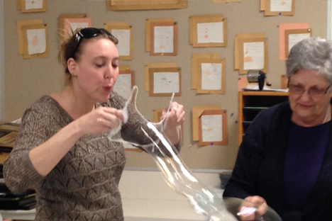 Student instructor experiments with blowing bubbles.